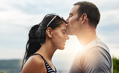 Buy stock photo Forehead, love or couple kiss on outdoor date, wellness or care on summer romance or adventure. Peace, smile or man with happy woman on holiday vacation together to bond, support or relax in nature