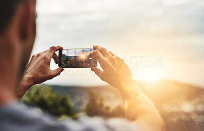 Buy stock photo Sunset, photography and hands of man with phone, screen and post on social media of nature, landscape or sun. Cellphone, photo and person with tech for memory of vacation, holiday or outdoor view 