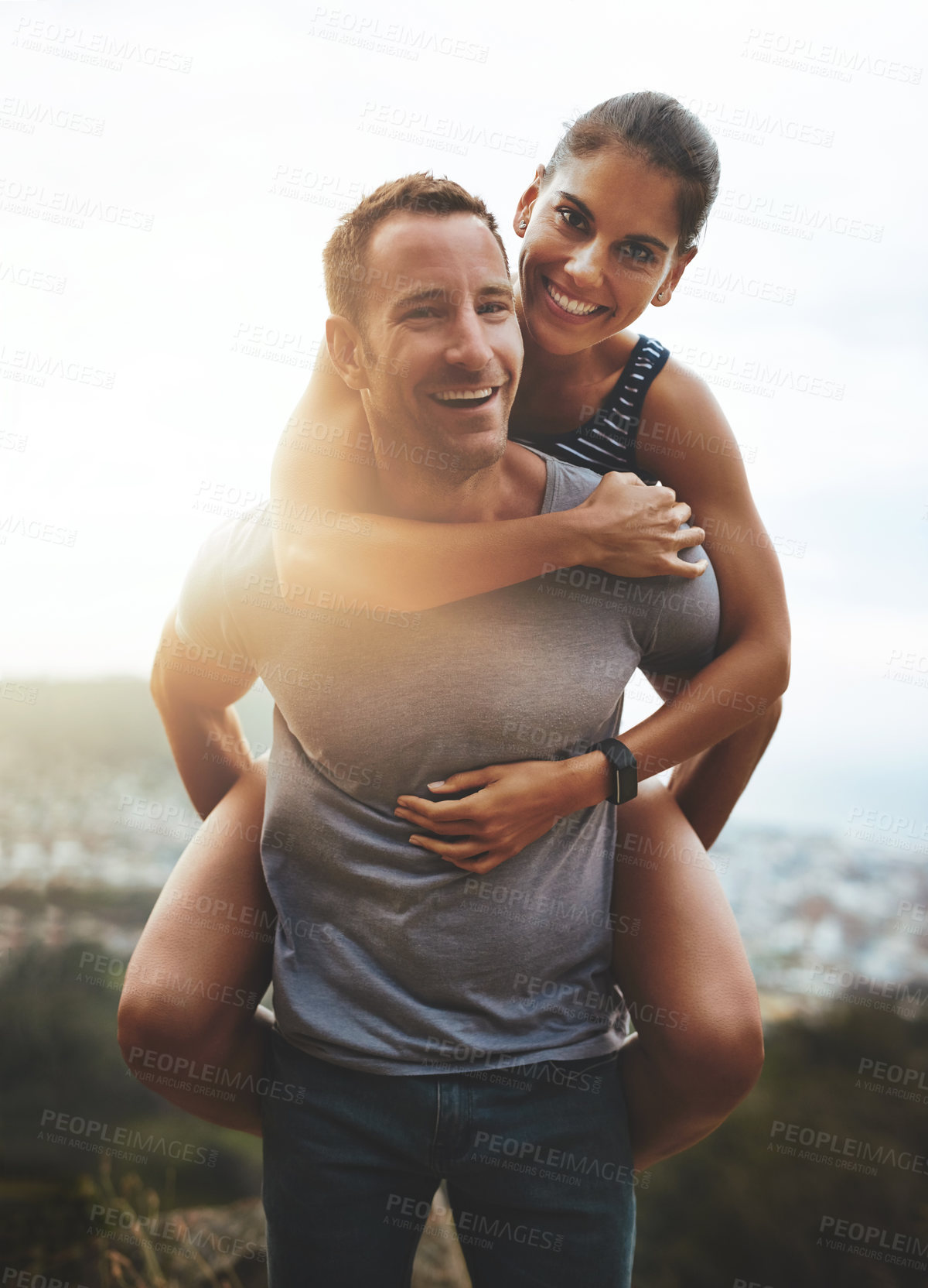 Buy stock photo Portrait, piggy back and couple with love, outdoor and lens flare with happiness, freedom and bonding. Face, man carrying woman and adventure with health, journey or outside with wellness or vacation