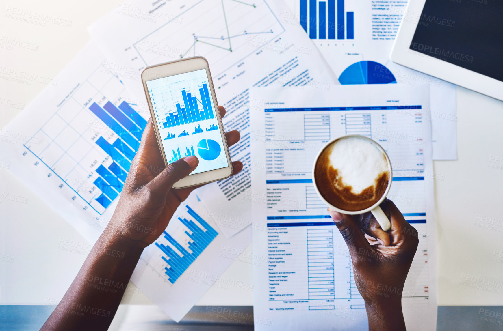 Buy stock photo High angle shot of an unidentifiable businesswoman drinking coffee while analyzing graphs on her smartphone