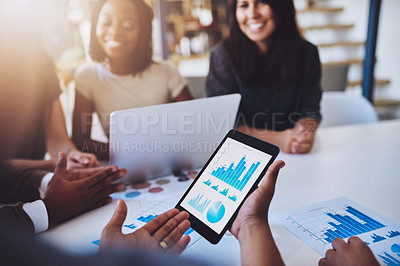 Buy stock photo Shot of a group of young businesspeople using wireless technology during a meeting in the office
