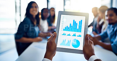 Buy stock photo Shot of an unidentifiable businessman holding up a tablet while sitting in a meeting with his colleagues
