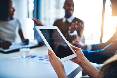 Buy stock photo Shot of an unidentifiable businesswoman holding a tablet during a meeting in the office