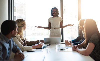 Buy stock photo Shot of a young businesswoman leading her team in a meeting in the office