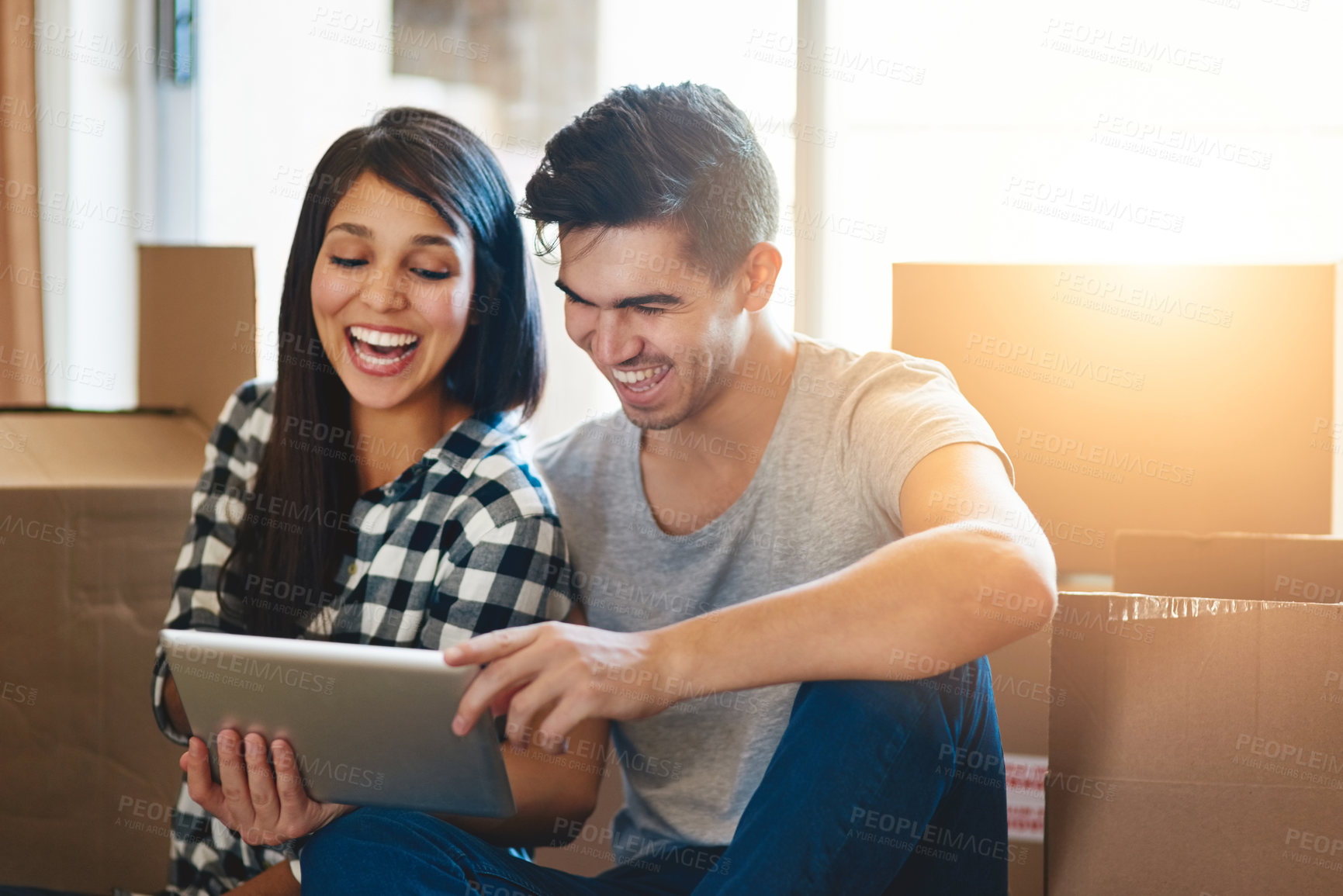 Buy stock photo Couple, tablet and boxes on floor in new home with reading, memory or meme on social media with property. People, man and woman on digital touchscreen, cardboard and package for real estate in house