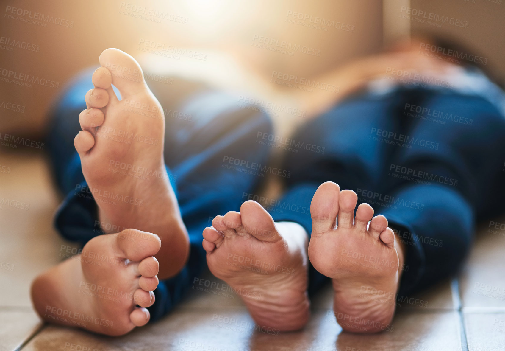 Buy stock photo Shot of an unidentifiable young couple resting on the floor while moving into their new house