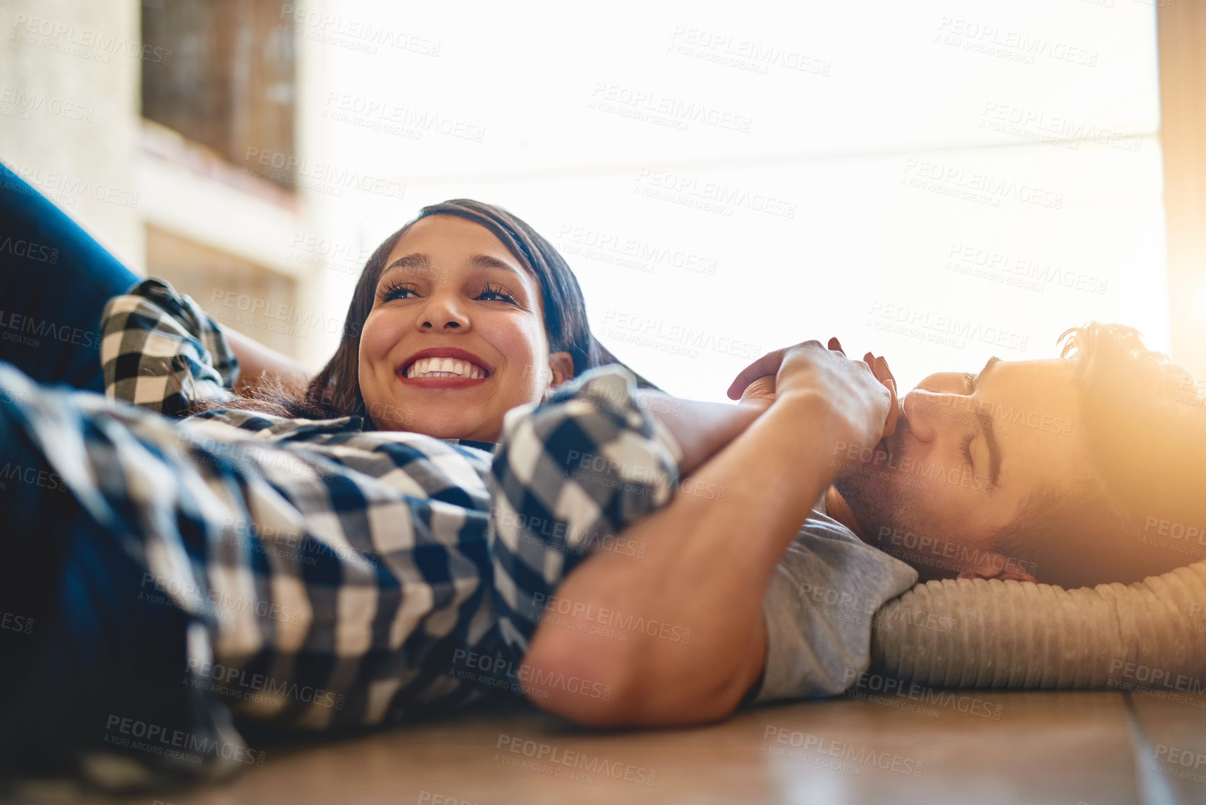 Buy stock photo Couple, love and kiss hands for romance on floor, bonding and support or security in relationship. Happy people, connection and commitment in marriage, relocation and affection for trust in new home