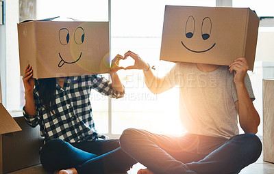 Buy stock photo New home, heart and couple with emoji on box for property, relocation and house investment. Love, marriage and man and woman with funny face for real estate mortgage, homeowner purchase and rental