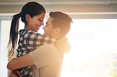 Buy stock photo Shot of a happy young couple celebrating their move into a new home