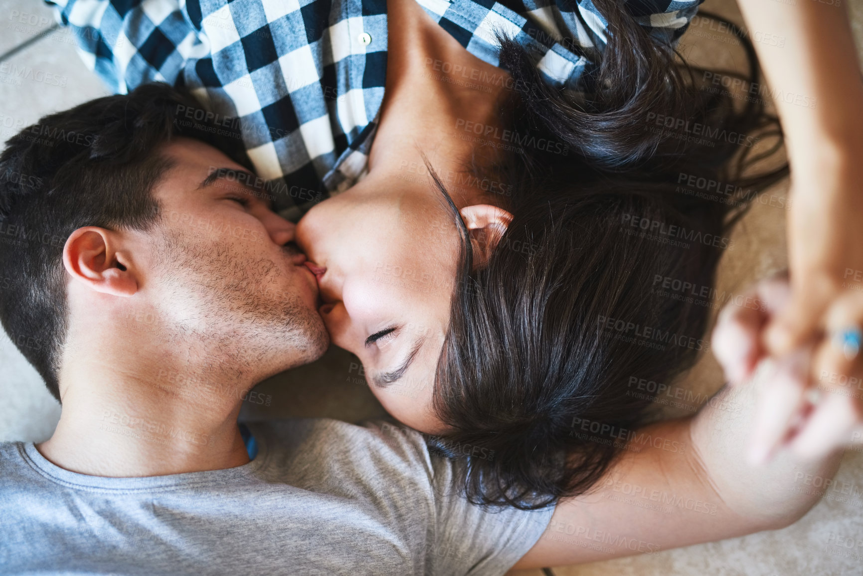 Buy stock photo Shot of a happy young couple resting on the floor while moving into their new house