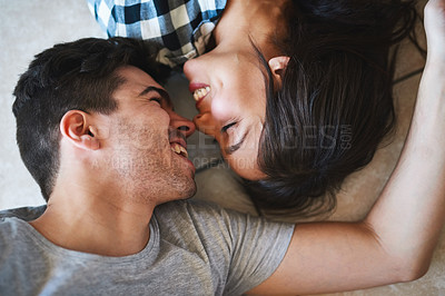 Buy stock photo Shot of a happy young couple resting on the floor while moving into their new house