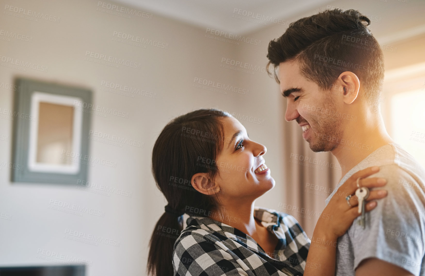 Buy stock photo Couple, love and keys for ownership of new home, hug and support or security in real estate. Happy people, connection and commitment in marriage, relocation and investment in property of dream house