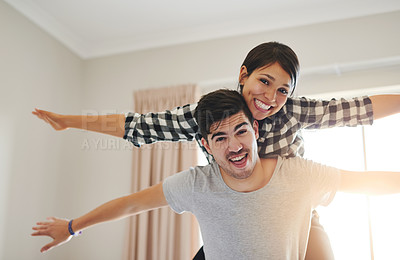 Buy stock photo Portrait of a happy young couple celebrating their move into a new home