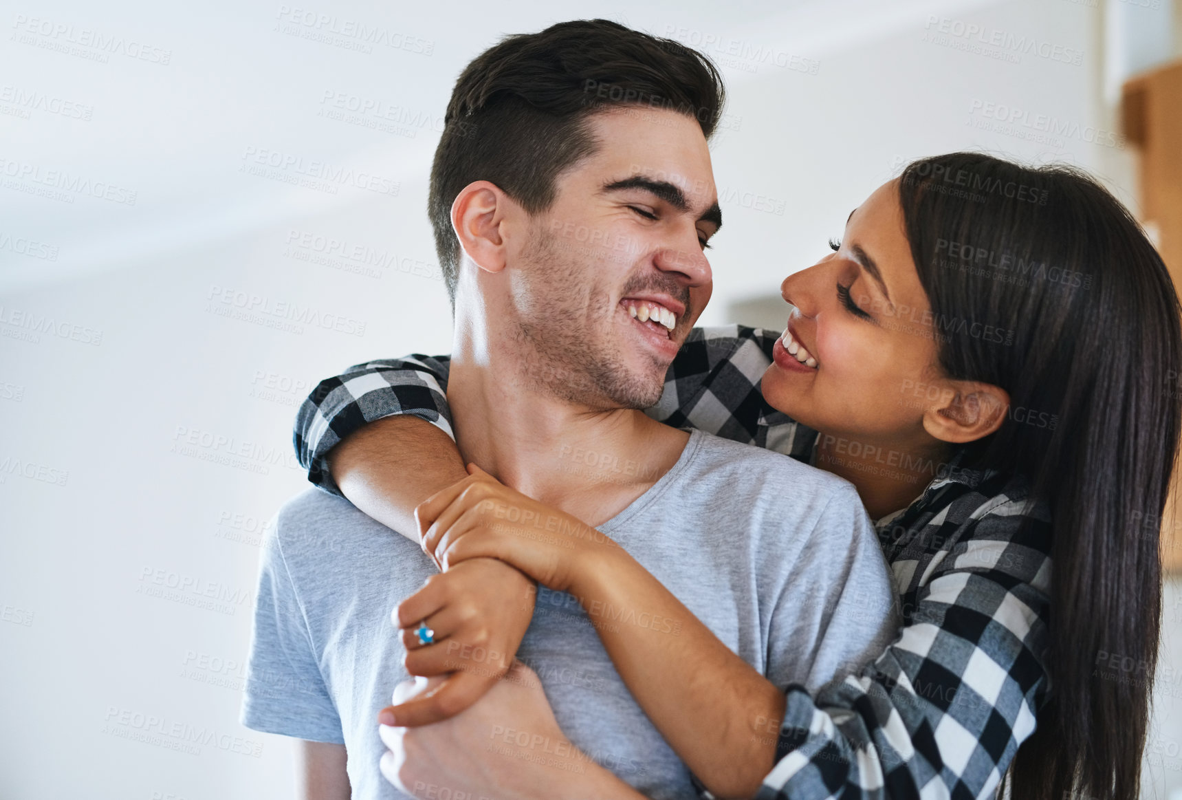 Buy stock photo Shot of a happy young couple celebrating their move into a new home