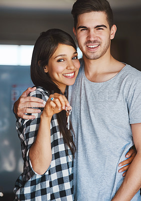 Buy stock photo Portrait of a happy young couple standing in the door of their new home