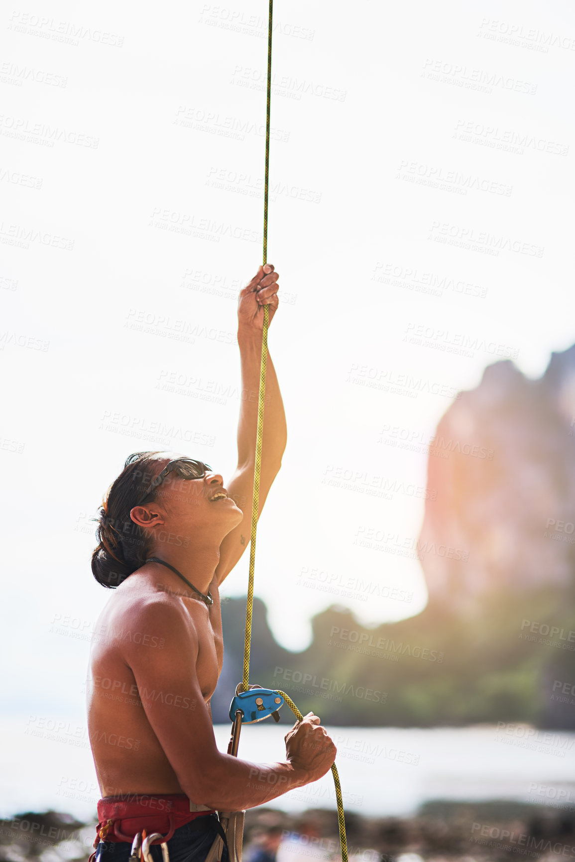 Buy stock photo Rock climbing, nature and man with rope for training, exercise and extreme sports on outdoor cliff. Mountain, travel and person with harness, equipment and gear for adventure, fitness and challenge