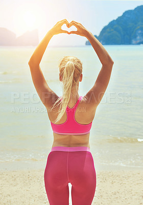 Buy stock photo Fitness, yoga and heart hands with woman on beach for wellness, mental health or exercise in nature. Environment, spiritual peace and athlete back doing warm up, zen wellbeing and ocean workout