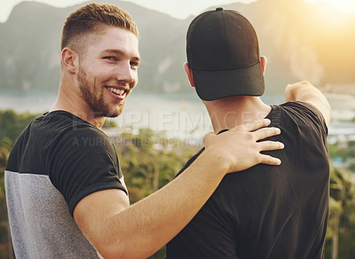 Buy stock photo Portrait of a young man looking over his shoulder while admiring the view outside with his friend