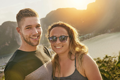 Buy stock photo Portrait of a happy young couple posing outside together