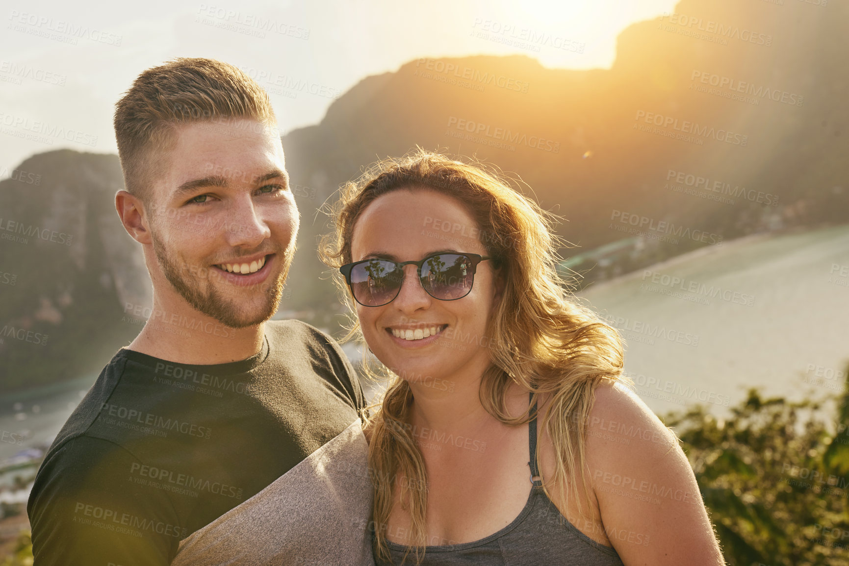 Buy stock photo Portrait of a happy young couple posing outside together