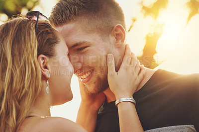 Buy stock photo Shot of an affectionate young couple standing together outdoors