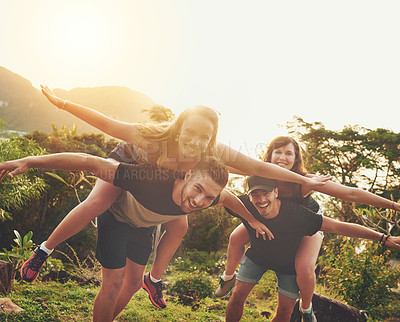 Buy stock photo Shot of a happy group of friends enjoying the day together outside