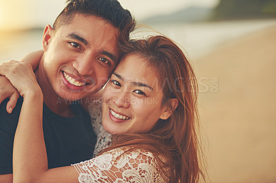 Buy stock photo Cropped shot of an affectionate couple spending the day on the beach