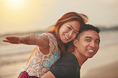 Buy stock photo Cropped shot of an affectionate couple spending the day on the beach
