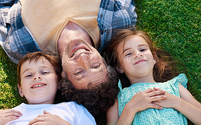 Buy stock photo Portrait, top view and father with children on grass for love relationship, bond together and smile for lazy weekend. Happiness, backyard lawn and face of dad with young kids for sunshine and relax