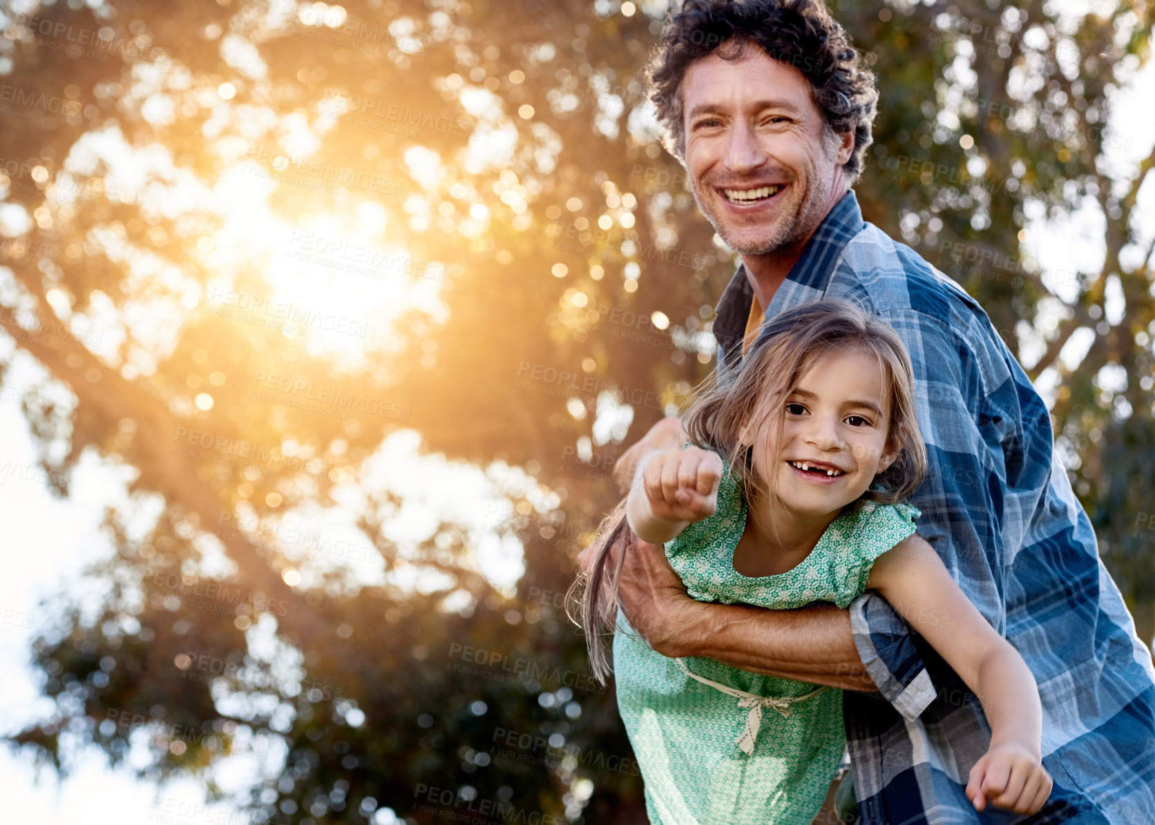 Buy stock photo Father, portrait and daughter playing plane outdoor with happiness for summer or holiday as family. Man, girl and smile by tree in garden with fun for freedom, love and fun together as superhero