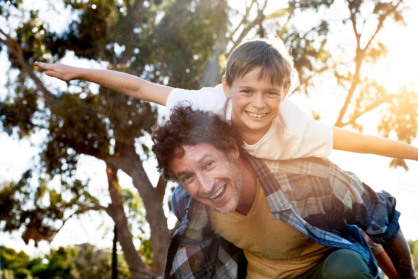 Buy stock photo Father, boy child and outdoor for piggy back with arms and smile, vacation in Australia with portrait. Male person, son and happy for game or playful in nature, support in summer and fun in England