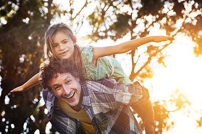 Buy stock photo Portrait of a happy father and daughter enjoying a piggyback ride outdoors