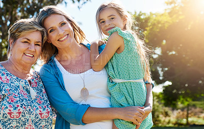 Buy stock photo Portrait of a young girl spending time with her mother and grandmother outdoors