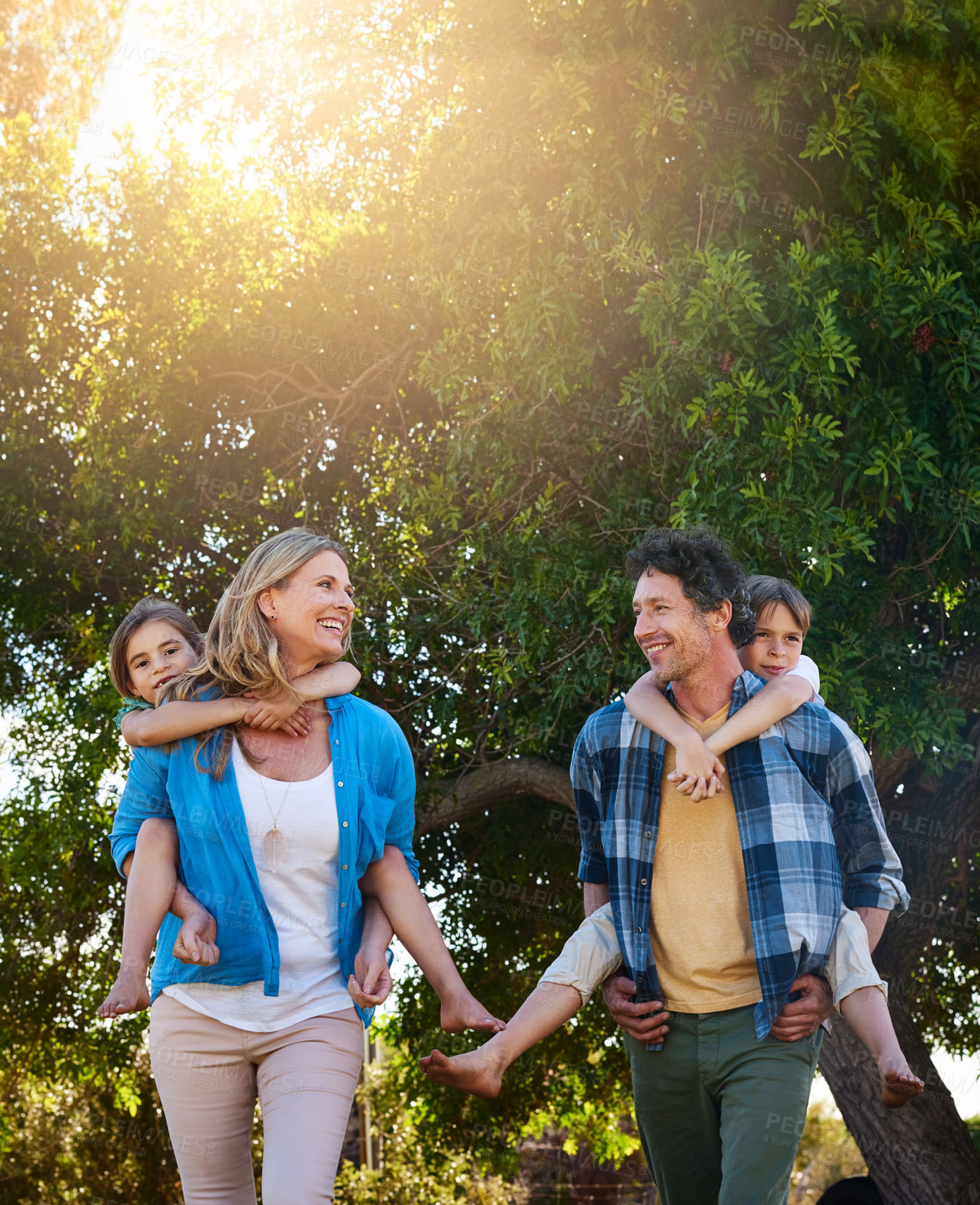 Buy stock photo Family, happy and piggyback in nature with love for bonding, weekend fun and games in park with sunshine. Parents, kids and carry on back for summer activity, outdoor scenery or smile on morning walk