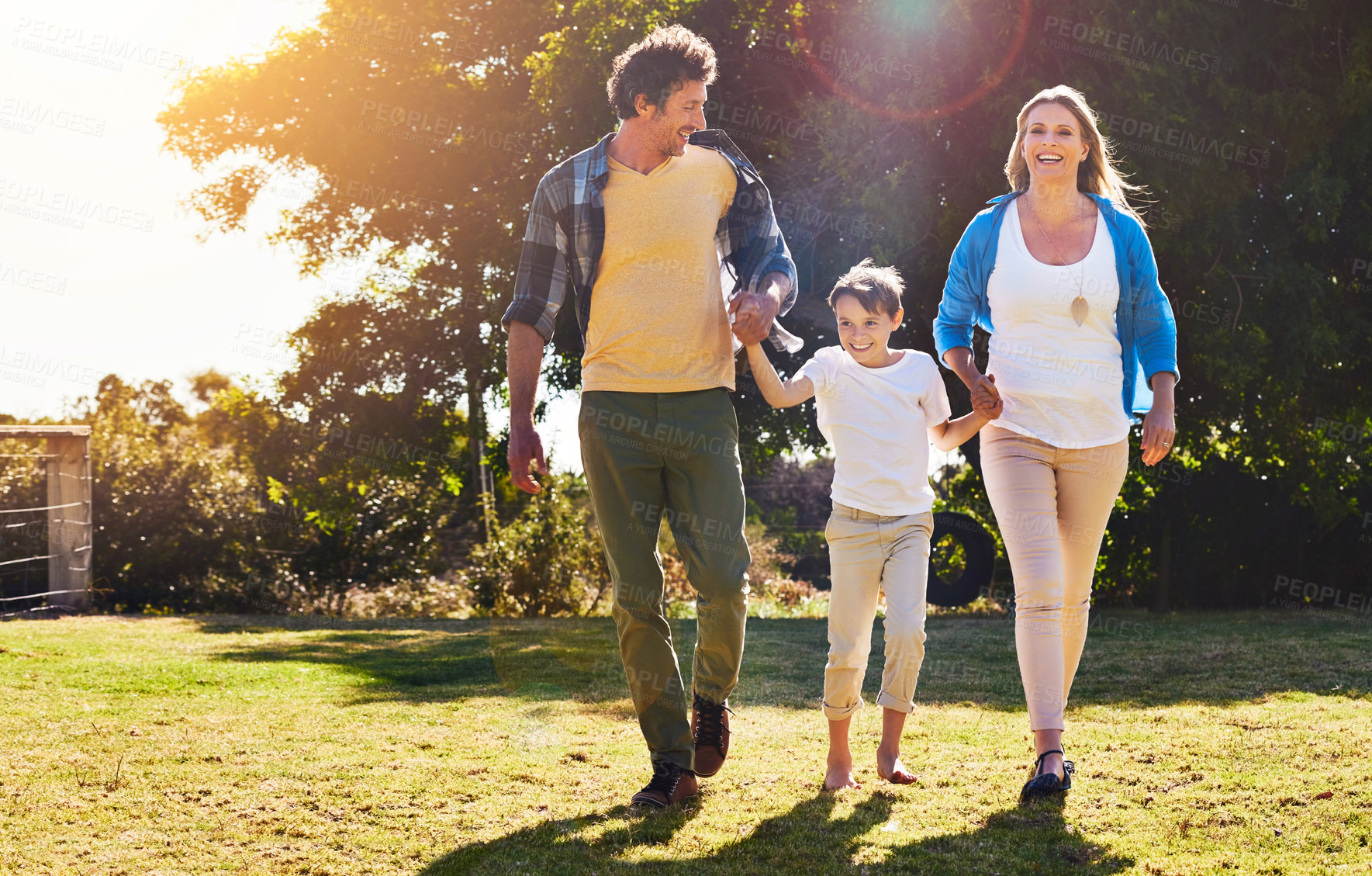 Buy stock photo Family, child and parents with holding hands in nature for weekend bonding, adventure and vacation. Man, woman and son with love at countryside for development, holiday and support on fathers day