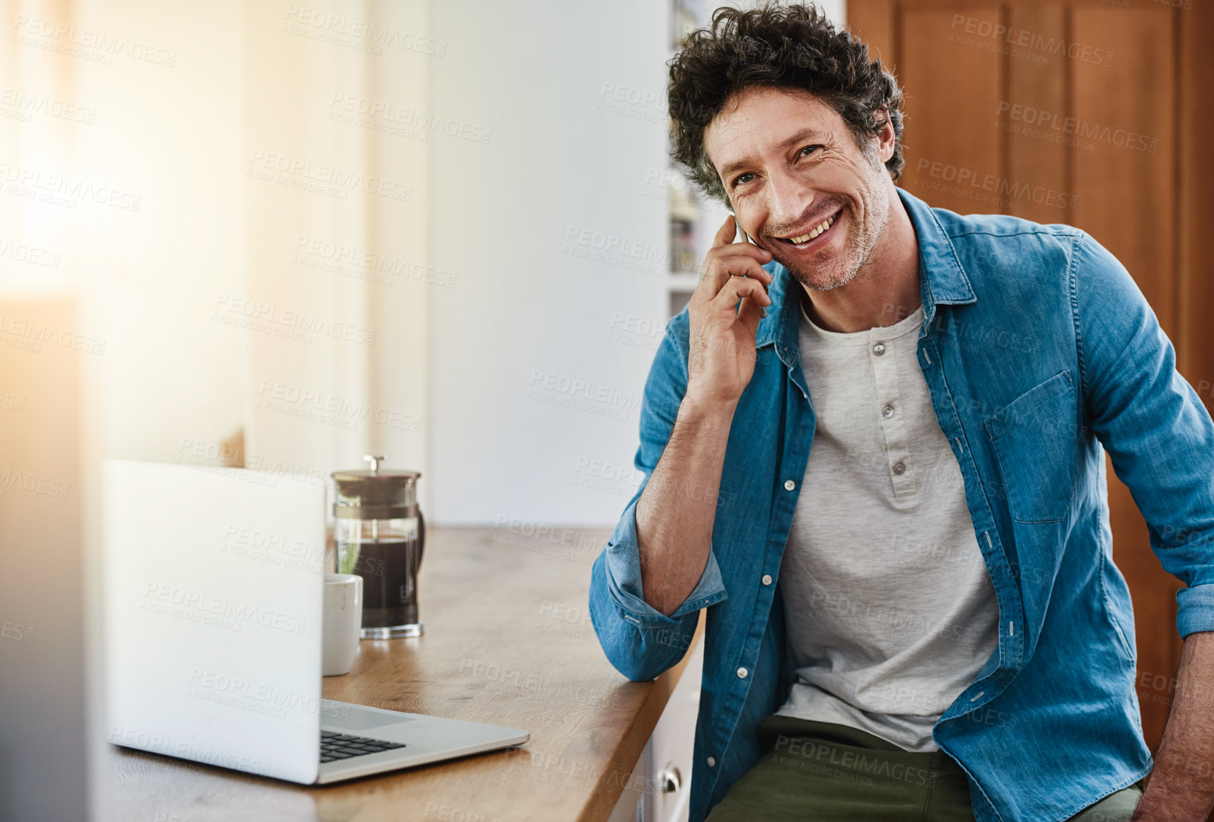 Buy stock photo Man, home and happy kitchen counter on phone call for networking, communication and connection. Discussion, conversation and smile with good news, approval and house finance or mortgage funds