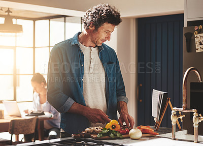 Buy stock photo Cooking, food and man cutting vegetables in the kitchen for diet, healthy or nutrition dinner. Recipe, book and mature male person from Canada chop ingredients for a supper or lunch meal at home.