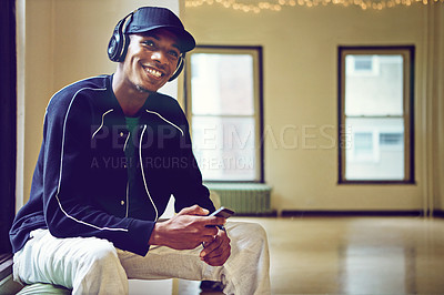 Buy stock photo Relax, headphones and man in corridor for music, break and  smile with cellphone for audio. Technology, podcast and online in waiting room, social media and smartphone for scrolling and streaming