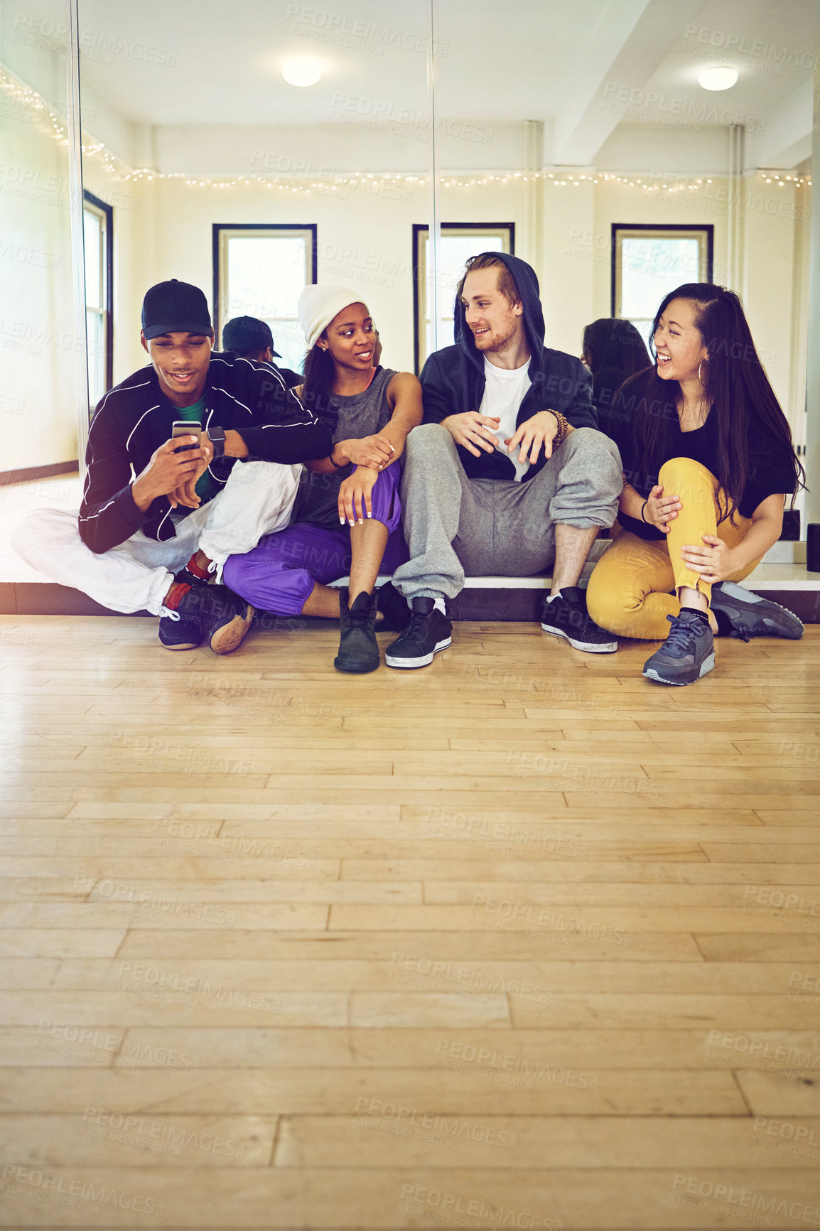 Buy stock photo Shot of a group of young friends hanging out in a dance studio