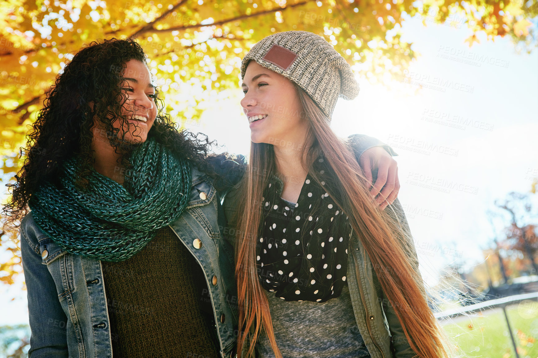 Buy stock photo Shot of two young friends enjoying a day at the park together