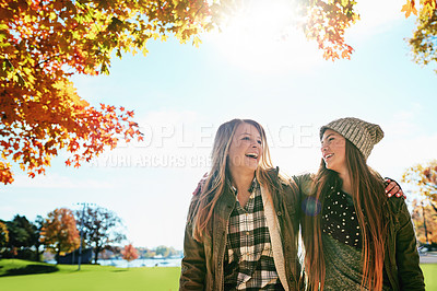 Buy stock photo Shot of two young friends enjoying a day at the park together