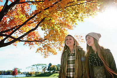 Buy stock photo Shot of two young friends enjoying a day at the park together