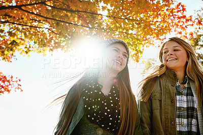 Buy stock photo Shot of two young friends enjoying a day at the park together