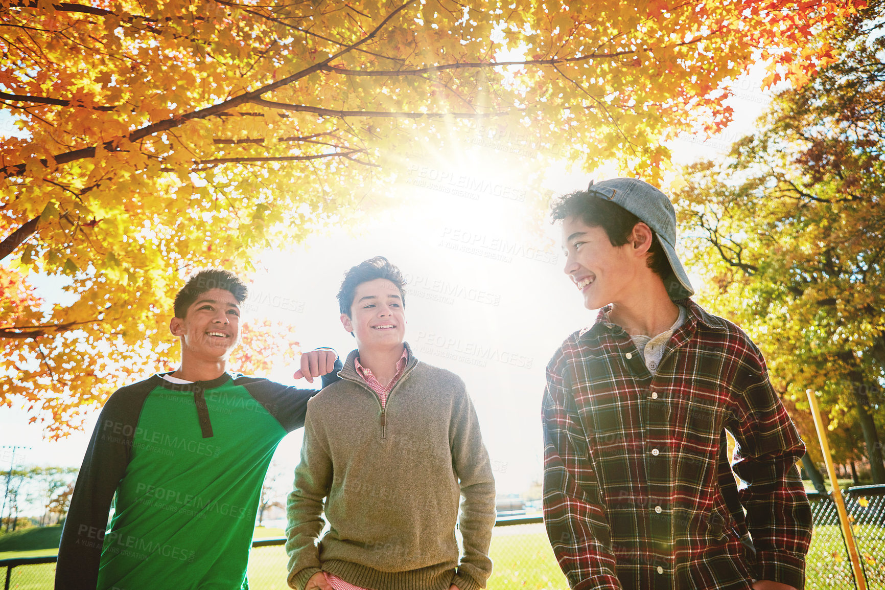 Buy stock photo Happy, boys or friends in park together for fall holiday, break or trust and support. Smiling, young men or group of teenagers walking in forest for talking, connection and outdoor adventure