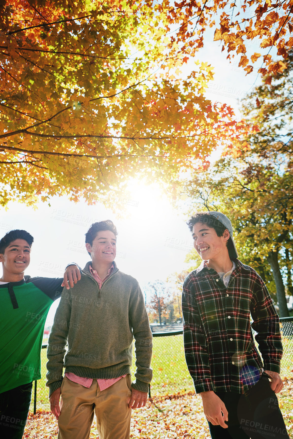 Buy stock photo Happy, boys or friends in park together for summer holiday, school break or support. Smiling, young men or group of teenagers walking in forest for talking, connection and outdoor adventure in sun