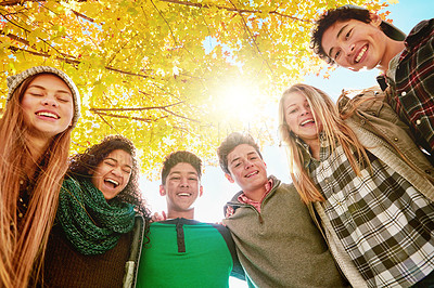 Buy stock photo Tree, happy and people with smile in nature for outdoor friendship, vacation and bonding together. Low angle, hug and group of teens in park for support, adventure and break on holiday in Australia