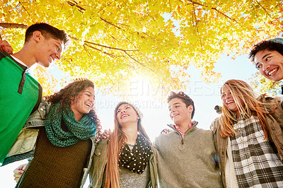 Buy stock photo Tree, happy and teen with smile in nature for outdoor vacation, adventure and bonding together. Low angle, hug and group of people in park for support, friendship and break on weekend in Australia