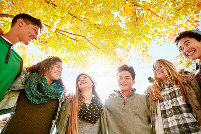 Buy stock photo Nature, smile and group of teens by tree for outdoor adventure, vacation and weekend together. Happy, low angle and people with hug in park for support, friendship and bonding on break in Australia