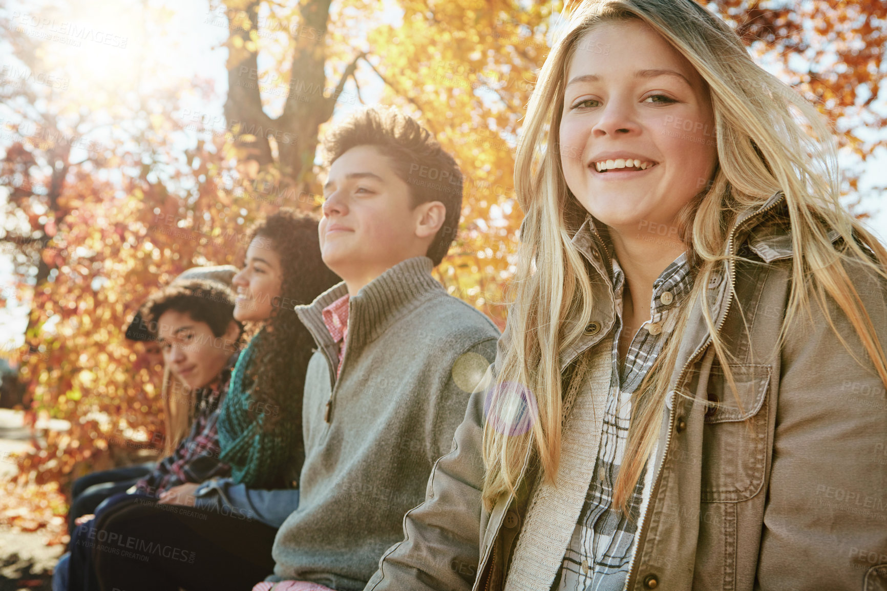 Buy stock photo Nature, portrait and group of happy teenagers on vacation, adventure or weekend trip together in Autumn. Smile, travel and young friends on holiday sit in outdoor garden, park or field in New Zealand