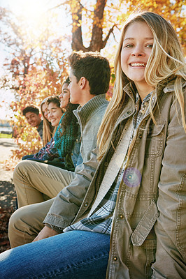 Buy stock photo Nature, portrait and group of teenagers on vacation, adventure or weekend trip together in Autumn. Smile, travel and young friends on holiday sitting in outdoor garden, park or field in New Zealand.